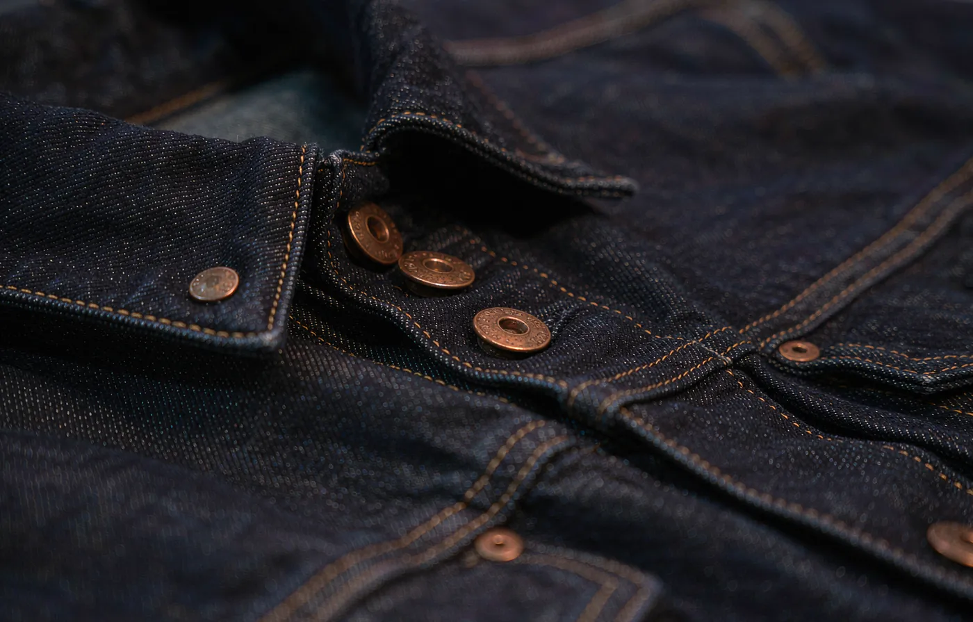 Dark denim jacket with copper shank buttons and rivets